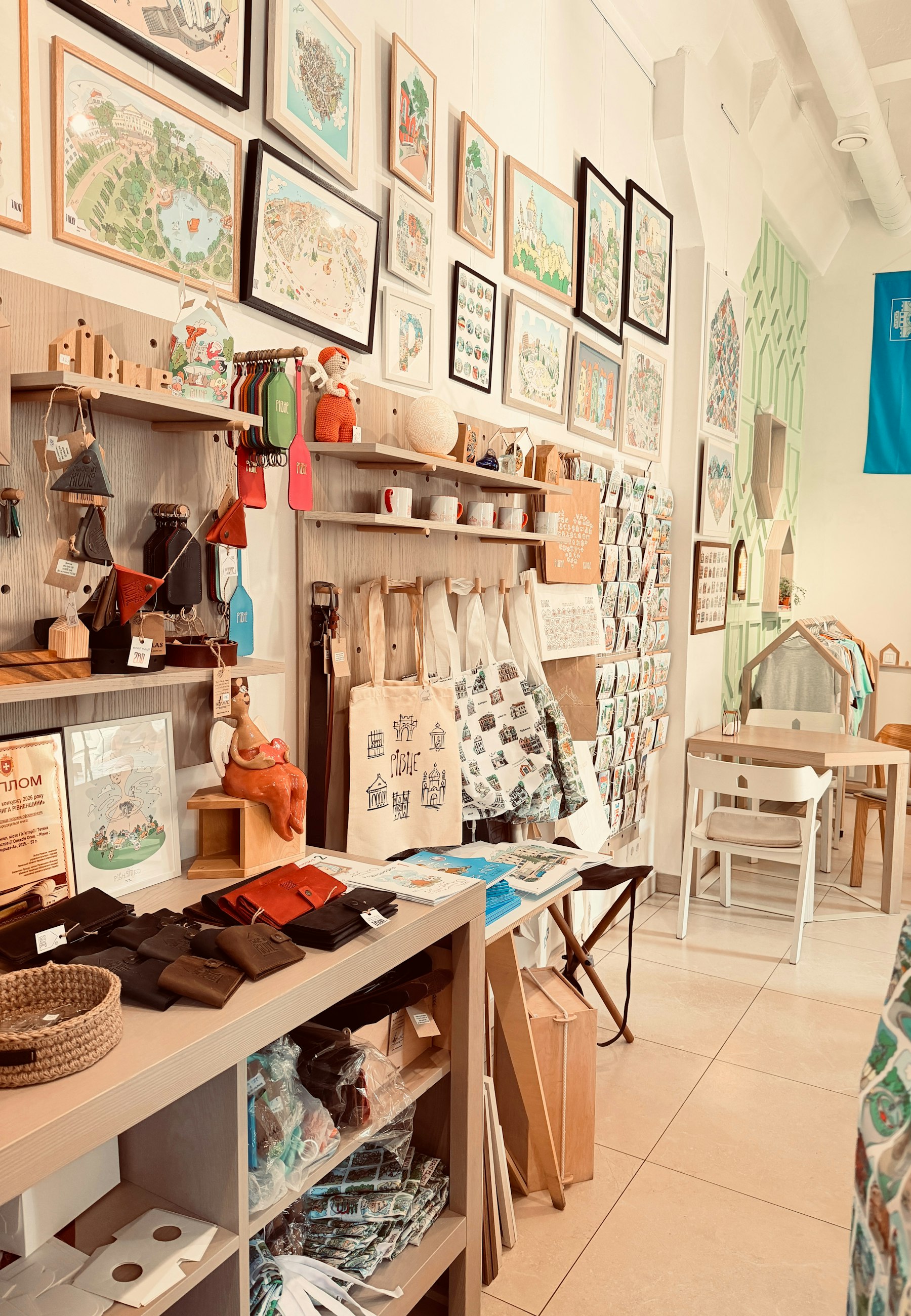 A cozy gift shop interior with shelves of handmade goods and framed artwork