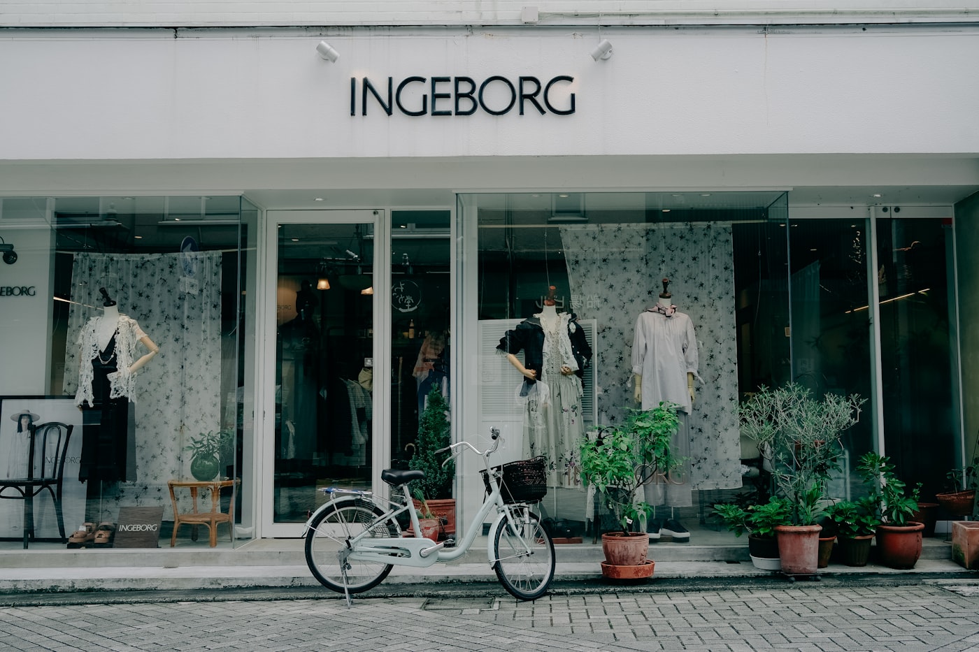 A storefront with a bicycle parked outside the front window