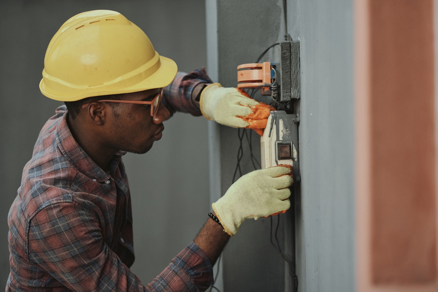 Electrician wiring a sub-panel during a new-construction rough-in