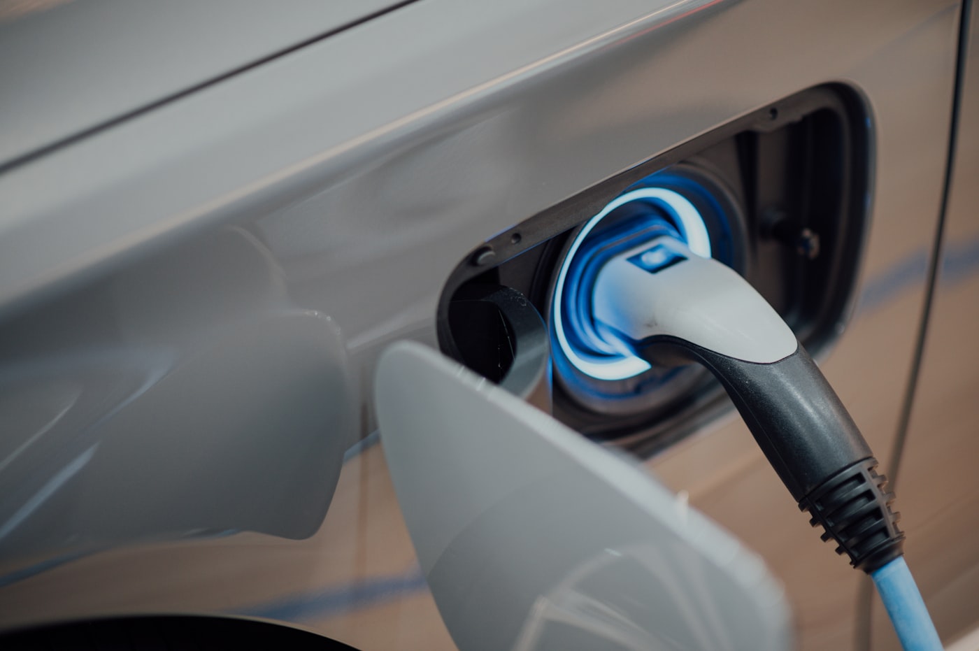 Electric vehicle charging port with connector plugged in
